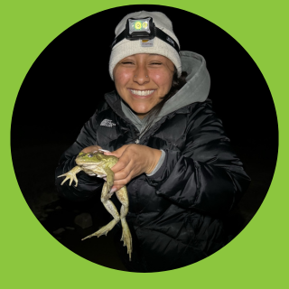 Student holding frog.